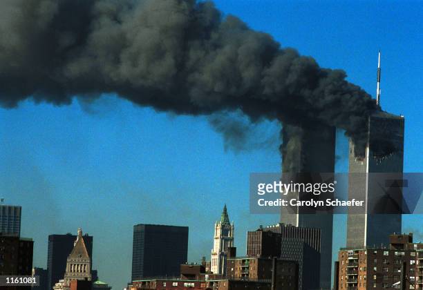 Smoke pours from the World Trade Center after being hit by two planes September 11, 2001 in New York City.
