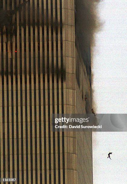 People jump to their deaths from the World Trade Center after it was hit by two planes and engulfed in smoke and flames during a suspected terrorist...