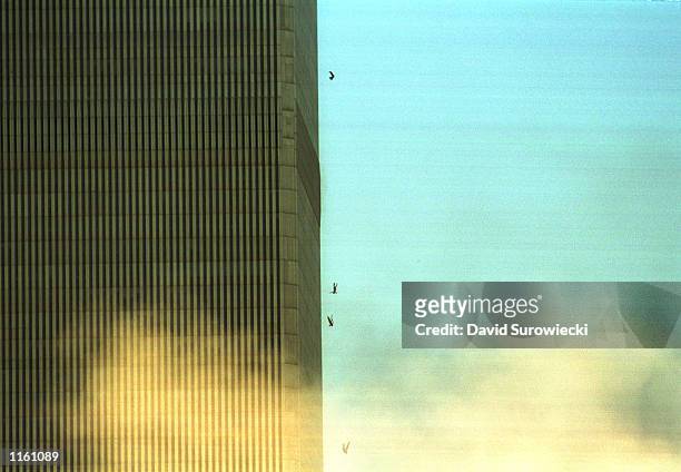 People jump to their deaths from the World Trade Center after it was hit by two planes and engulfed in smoke and flames during a suspected terrorist...