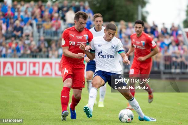 Amine Harit of Schalke 04 fights for the ball against Alexander Neumann of Drochtersen during the DFB Cup first round match between SV...