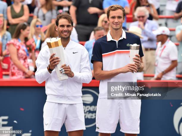 Rafael Nadal of Spain and Daniil Medvedev of Russia pose with their trophies during the mens singles final on day 10 of the Rogers Cup at IGA Stadium...