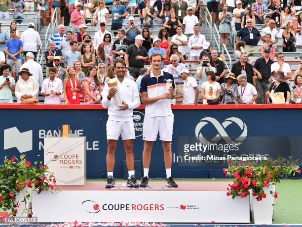 Rafael Nadal of Spain and Daniil Medvedev of Russia pose with their trophies during the mens singles final on day 10 of the Rogers Cup at IGA Stadium...