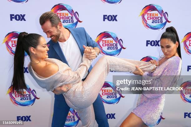 Retired US wrestlers Nikki Bella and Brie Bella and Russian-US dancer Artem Chigvintsev attend the 2019 Teen Choice Awards in Hermosa Beach,...