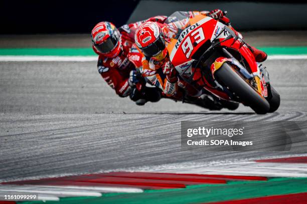 Repsol Honda Team's Spanish rider Marc Marquez leads in front of Ducati Team's Italian rider Andrea Dovizioso during the Austrian MotoGP Grand Prix...