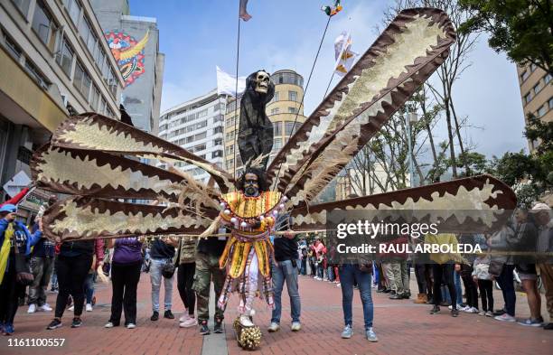 Actors perform during a parade honoring Colombia's Independence Bicentennial, part of Summer Festival celebrations in Bogota on August 11, 2019.