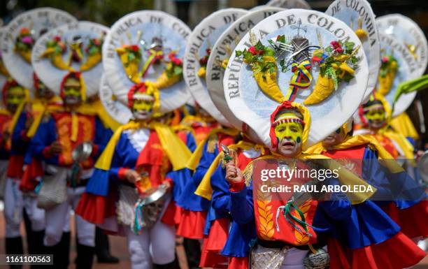 Actors perform during a parade honoring Colombia's Independence Bicentennial, part of Summer Festival celebrations in Bogota on August 11, 2019.