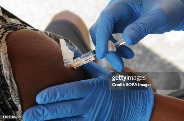 Nurse from the Orange County, Florida Health Department administers the hepatitis A vaccine to an attendee at a hepatitis A vaccination event being...