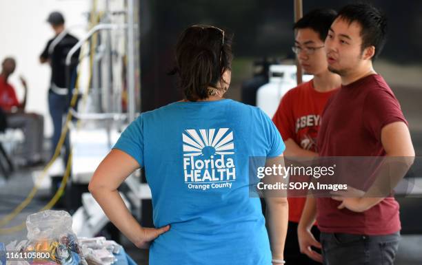 Alvina Chu of the Orange County, Florida Health Department offers services to people at a hepatitis A vaccination event being held in response to the...