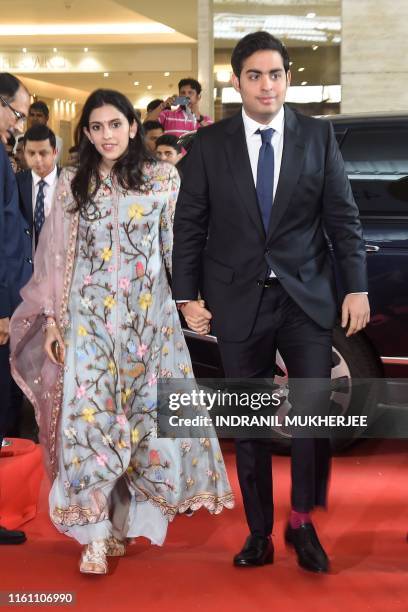 Akash Ambani, son of India's richest man and oil-to-telecom conglomerate Reliance Industries chairman Mukesh Ambani, and his wife Shloka arrive for...