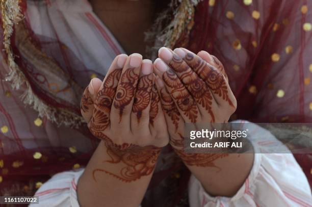 Muslim woman offers pray during Eid al-Adha prayers at the Badshahi Mosque in Lahore on August 12, 2019. - Muslims around the world are celebrating...