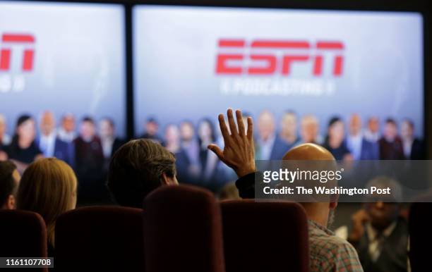 Staff watches a presentation with Vice President of ESPN Norby Williamson, who also oversees SportsCenter, during a meeting in the executive...