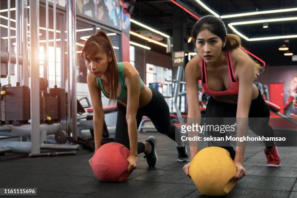 fit female doing intense core workout in gym. young muscular woman doing core exercise on fitness mat in health club. - core strength stock pictures, royalty-free photos & images