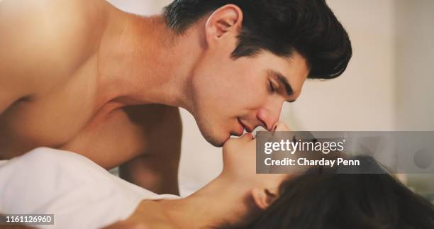 i'll never get tired of this - man kissing woman in bed stock pictures, royalty-free photos & images