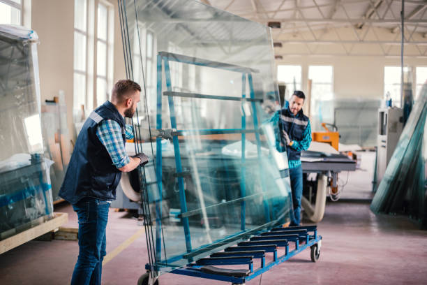 workers packaging glass sheets in warehouse