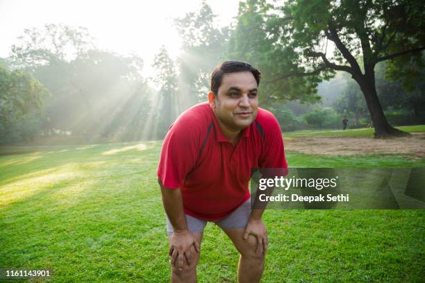 mature man workout in park - fat asian man stock pictures, royalty-free photos & images