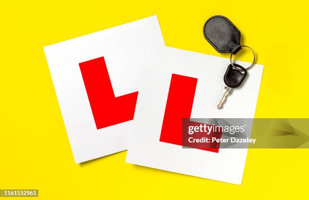 l plates and car key on yellow - learning to drive stock pictures, royalty-free photos & images