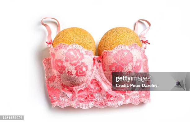 melons in bra, showing potential breast size for cosmetic surgery - große brüste stock-fotos und bilder