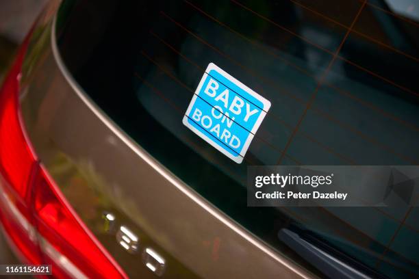 blue baby on board sticker in rear view window of car - car rear imagens e fotografias de stock