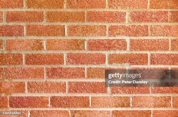 red brick wall close up - brick pattern stock-fotos und bilder