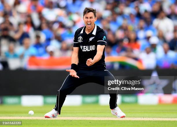 Trent Boult of New Zealand celebrates trapping Virat Kohli of India LBW during the Semi-Final match of the ICC Cricket World Cup 2019 between India...