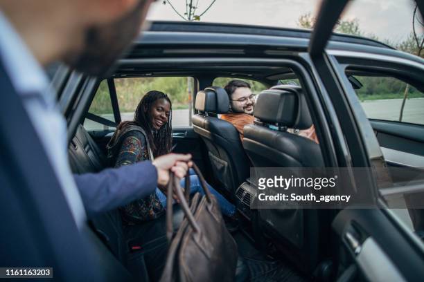 man entering a ride sharing car - carpool stock pictures, royalty-free photos & images