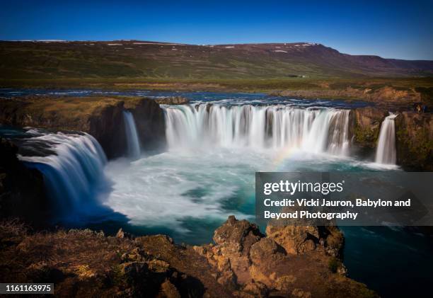 dramatic godafoss waterfall from above in northern iceland in summer - above and beyond stock pictures, royalty-free photos & images