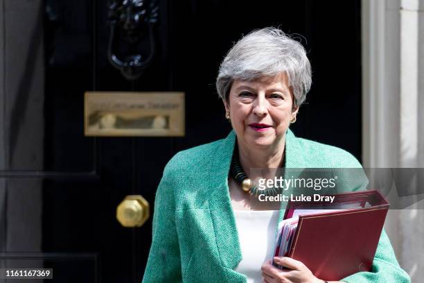 British Prime Minister, Theresa May, leaves Downing Street to attend the weekly Prime Ministers Questions in Parliament on July 10, 2019 in London,...