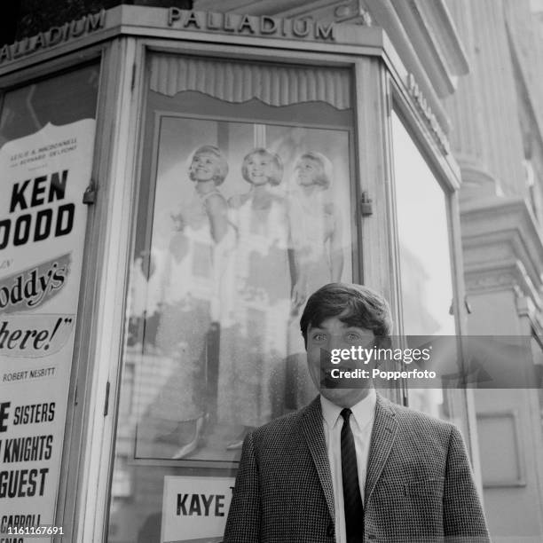 English comedian Jimmy Tarbuck posed outside the London Palladium Theatre on Argyll Street in London in September 1965.