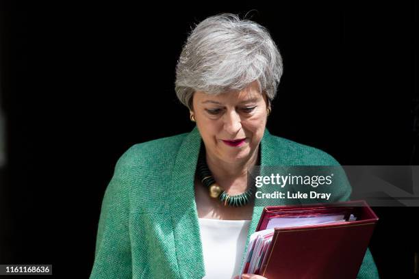 British Prime Minister, Theresa May, leaves Downing Street to attend the weekly Prime Ministers Questions in Parliament on July 10, 2019 in London,...