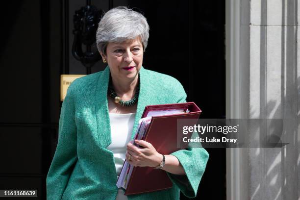 British Prime Minister, Theresa May, leaves Downing Street to attend the weekly Prime Ministers Questions in Parliament on July 10, 2019 in London,...