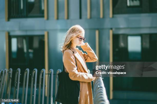 young businesswoman in modern city - tote bag stock pictures, royalty-free photos & images
