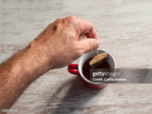 cup of tea being made by a man - making tea stock pictures, royalty-free photos & images