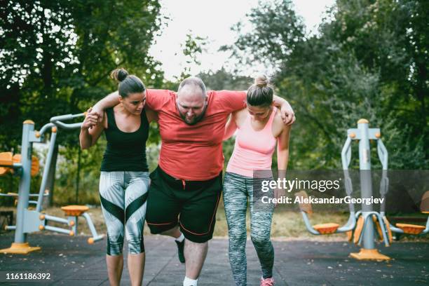 friendship is about help and compassion - fat man lying down stock pictures, royalty-free photos & images