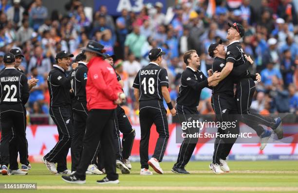 The New Zealand side celebrate as MS Dhoni of India is run out by Martin Guptill of New Zealand during the Semi-Final match of the ICC Cricket World...