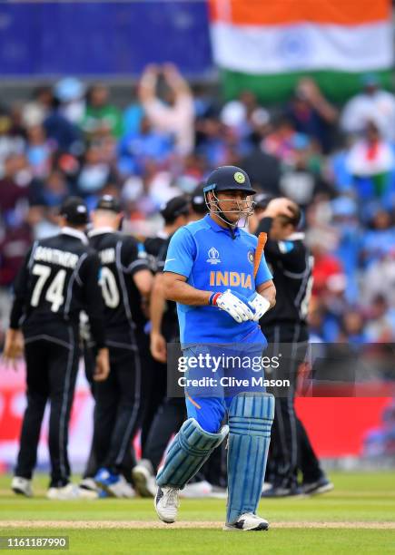 Dhoni of India walks as he is run out by Martin Guptill of New Zealand during resumption of the Semi-Final match of the ICC Cricket World Cup 2019...