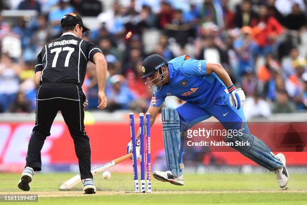 Dhoni of India is run out by Martin Guptill of New Zealand during resumption of the Semi-Final match of the ICC Cricket World Cup 2019 between India...