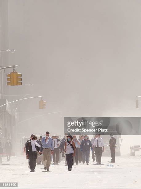 Dust swirls around south Manhattan moments after a tower of the World Trade Center collapsed September 11, 2001 in New York City after two airplanes...