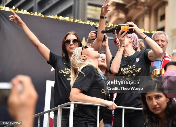 Alex Morgan, Ali Krieger and Megan Rapinoe celebrate during a Victory Ticker Tape Parade for the U.S. Women's National Soccer Team down the Canyon of...