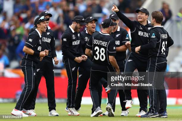 Martin Guptill of New Zealand celebrates with team mates after running out MS Dhoni during the Semi-Final match of the ICC Cricket World Cup 2019...