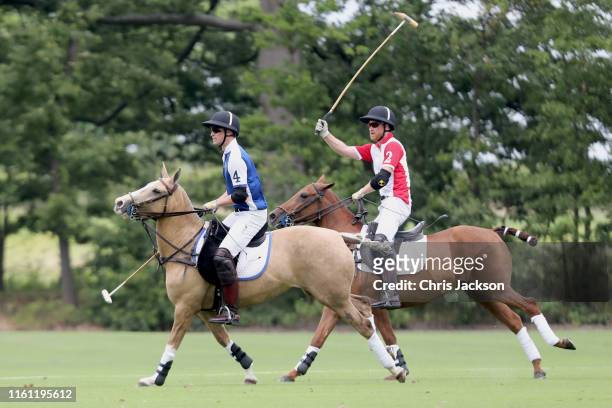 Prince William, Duke of Cambridge and Prince Harry, Duke of Sussex compete during the King Power Royal Charity Polo Day for the Vichai...