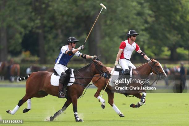 Prince William, Duke of Cambridge and Prince Harry, Duke of Sussex compete during the King Power Royal Charity Polo Day for the Vichai...