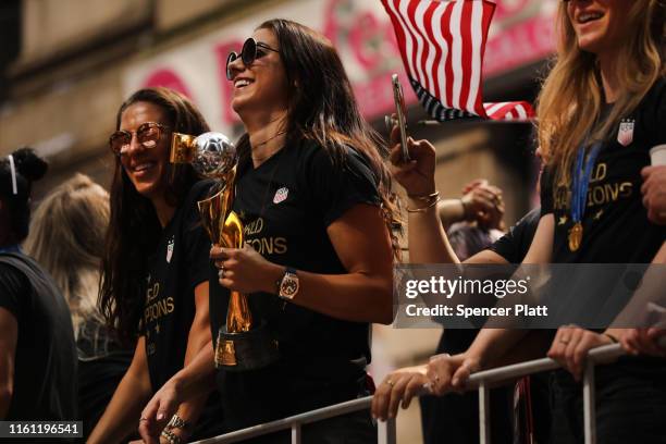 Carli Lloyd and Alex Morgan celebrate while riding on a float during the U.S. Women's National Soccer Team Victory Parade through the Canyon of...