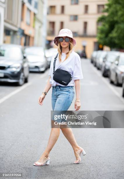 Inga Brauer is seen wearing oversize shirt Zara, bermuda jeans Noisy May, bucket hat New Look, vinyl high heels Stadivarius, black Off White bag,...