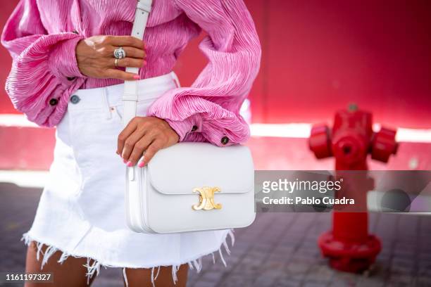 Paula Ordovas wears Ganni shirt, Levis skirt, Celine handbag, Jimmy Choo shoes, Mercedes Salazar earings and Gigi Barcelona sunglasses during...