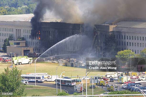 Smoke comes out from the west wing of the Pentagon building September 11, 2001 in Arlington, Va., after a plane crashed into the building and set off...