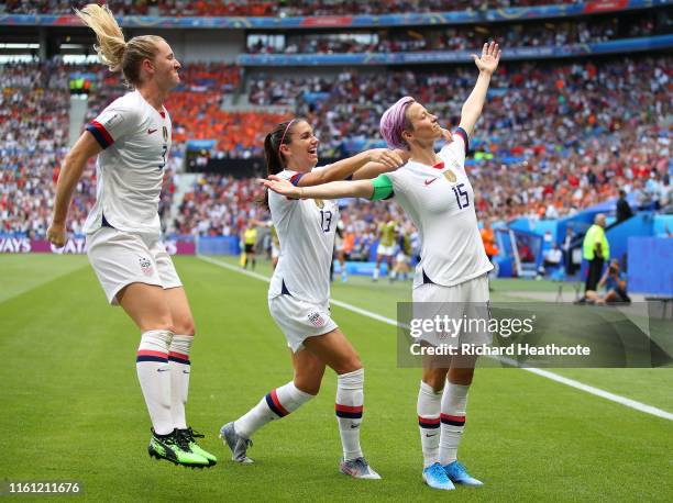 Megan Rapinoe of the USA celebrates scoring the first goal from the penalty spot with Alex Morgan during the 2019 FIFA Women's World Cup France Final...