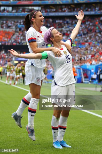 Megan Rapinoe of the USA celebrates scoring the first goal from the penalty spot with Alex Morgan during the 2019 FIFA Women's World Cup France Final...