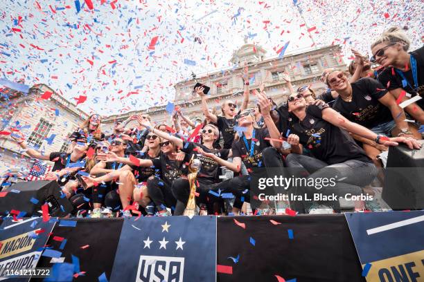 Members of the USA Women's National Soccer Team stand in front of the 2019 FIFA World Cup Trophy and get showered by confetti after the City Hall...