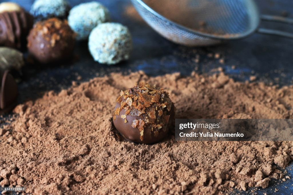The process of making chocolate candies. andy on a table dusted with cocoa.