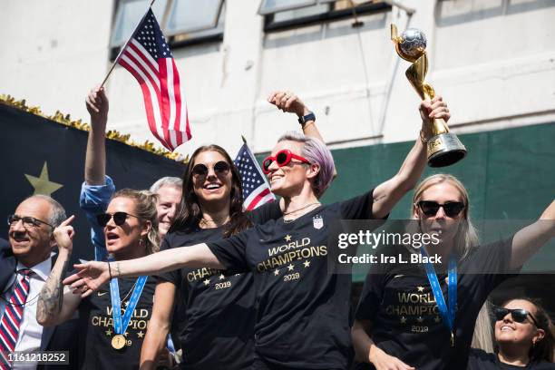 Megan Rapinoe of United States holds the 2019 FIFA World Cup Champion Trophy, Ashlyn Harris of United States Alex Morgan of United States and Allie...